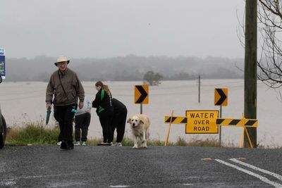 Record rainfall displaces 50,000 people as Sydney’s wild weather moves north