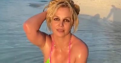 Britney Spears shows off toned figure at the beach on 'rainy' honeymoon with Sam Asghari