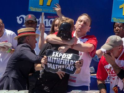 Joey Chestnut tackles protester while achieving another hot dog eating record on July 4