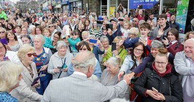 Crowds waving Welsh flags and Union Jacks greet Prince Charles and Camilla in Treorchy