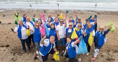 National Lottery winners with £25million in bank spend day cleaning filthy beach