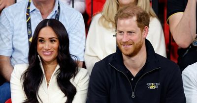 Meghan Markle and Prince Harry spotted watching parade as Archie clutches US flag