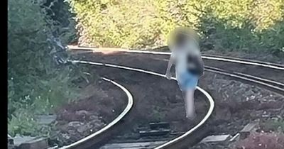 Trains stopped after woman climbed onto tracks and started walking down them