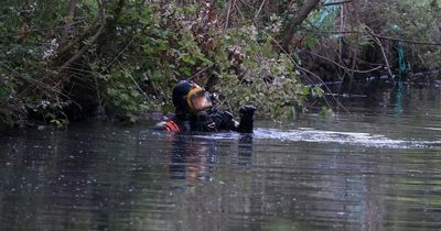 Police search team trawl canal with divers and Tactical Aid Unit officers at scene