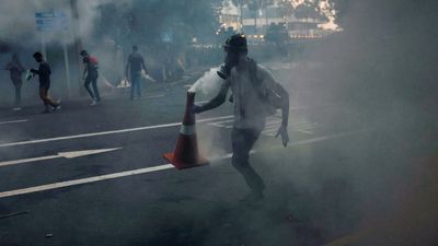 Sri Lanka imposes curfew in capital as police fire tear gas at protesters