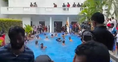 Thousands storm president's home and jump in swimming pool amid economic collapse