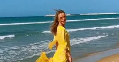 Amanda Holden stuns in a tiny yellow bikini as she takes a dip in the sea on Sicily trip