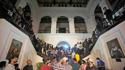 Sri Lanka’s PM and president quit after crowds storm presidential palace with some making tea and using swimming pool