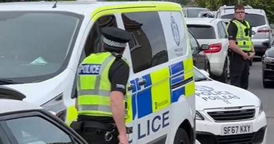 Police escort man from house in Glasgow after crowd gathers outside chanting 'beast'