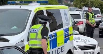 Barrhead crowd bawls abuse as police escort man from house amid angry protest