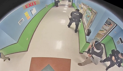 Video inside Uvalde school shows officer stopping for hand sanitizer and police fleeing gunman