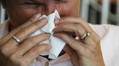 Flu season in NSW has peaked but worst yet to come from new COVID wave, authorities say