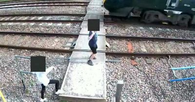 CCTV catches children dancing in front of oncoming train