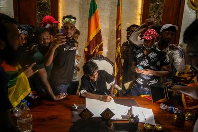 AP PHOTOS: Sri Lankans swarm leaders' domains, vow to stay