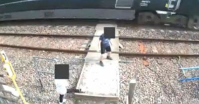 Children DANCE on tracks in front of oncoming 125mph train as adults watch