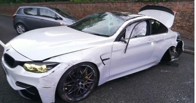 Car hits wall then flips over near QMC