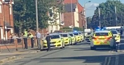 Police tape off street as air ambulance lands at 'stabbing' scene