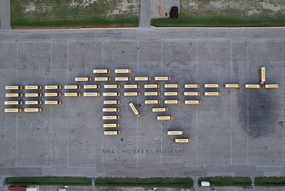 Fleet of school buses formed like rifle protests gun violence against children at Ted Cruz’s home