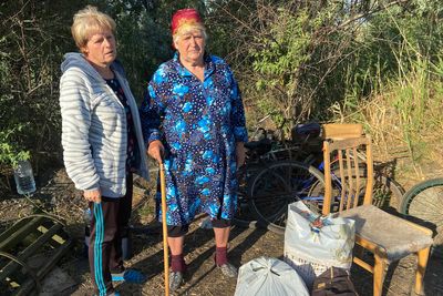 Ukrainian villagers flee Russian-occupied Kherson on foot, bike and wheelchair