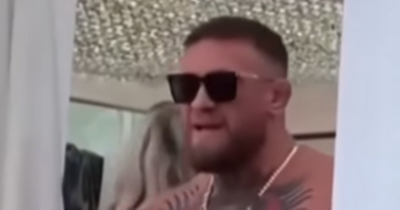 Conor McGregor angrily stamps on fan's hat after it's thrown at him while partying in Ibiza