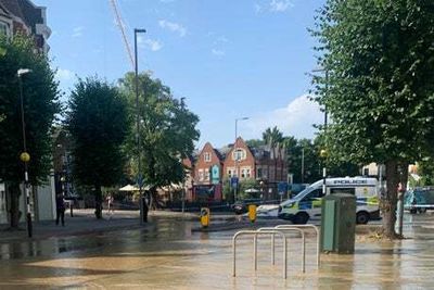 Drain water streams from burst water main down Kingston Hill into shoppers amid heatwave