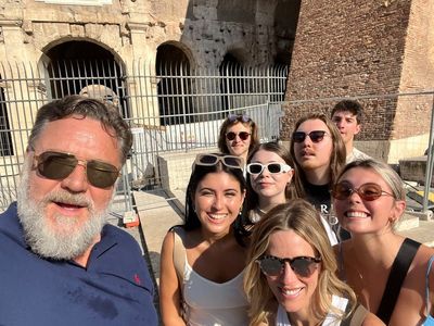 ‘Taking the kids to see my old office’: Gladiator star Russell Crowe takes family selfie outside Colosseum