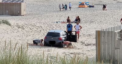 BMW gets stuck on the beach after ignoring 'no vehicles' sign