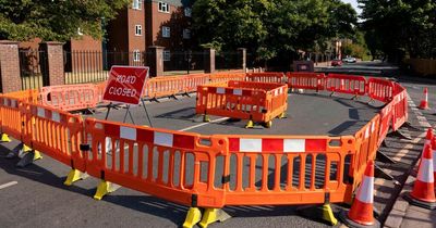 Busy road closed and traffic queuing as 'sinkhole' opens