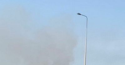 Huge emergency response as crews tackle major grass fire in soaring heat near Salford