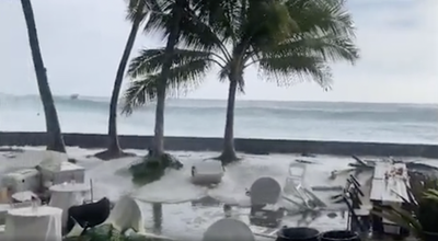 Watch: Historic waves crash over two-storey buildings and a wedding party in Hawaii