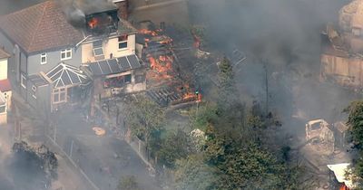 Homes engulfed in flames as 100 firefighters tackle huge blaze amid 40C heat