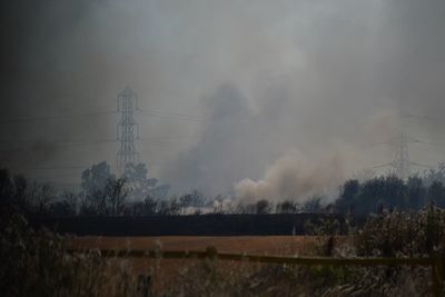 UK temperatures soar above 40C for first time with transport chaos and fires