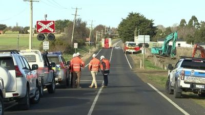 Man dies, another injured, after excavator rolls at railway worksite in Tasmania