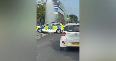 Moment water shoots into the air as 'vandals' set off fire hydrant on busy Manchester road