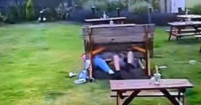 Two lads in Leeds pub beer garden go viral after CCTV captures them falling backwards off bench