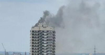 Fire tears through London tower block as smoke billows from top floor windows