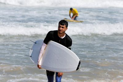 With eyes on the waves, Gaza surfers keep boards handy