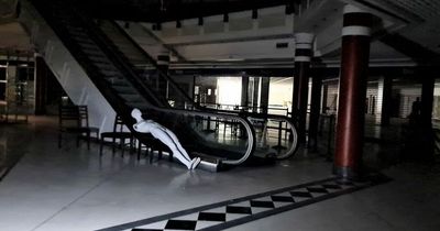 Inside abandoned shopping centre that looks like setting for classic zombie movie