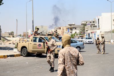 Fighting rips through Libyan capital, killing 13
