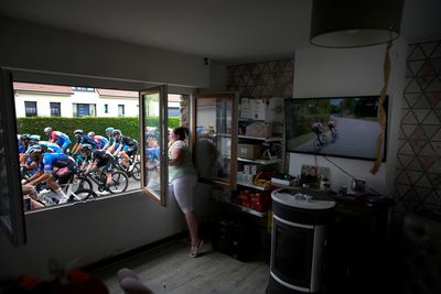 AP PHOTOS: Tour de France cyclists pass by in a flash