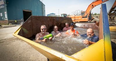 Sweltering workers turn rusty skip into makeshift swimming pool amid 38C heatwave highs
