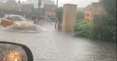 Met Office issues yellow warning for rain and storms as cars struggle through flooding