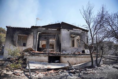 Fire damages homes in southern Greece; more blazes active