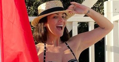 Martine McCutcheon confidently poses in striped bikini as she enjoys family holiday