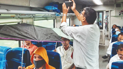 Maharashtra: Umbrellas out inside train coach with a leaky roof