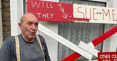 Man fumes after signs protesting his neighbours' extension are torn down