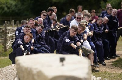 Sailors use wooden sled and ropes to erect standing stone at visitor attraction