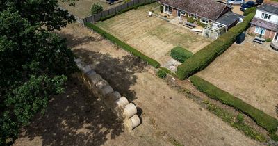 Millionaire builds wall of hay bales so he doesn't have to look at his neighbour's washing
