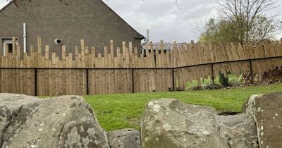 Woman swaps seat with colleague as wonky fence 'puts her off her work'