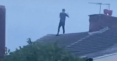 Road closed and man on roof arrested after police chase